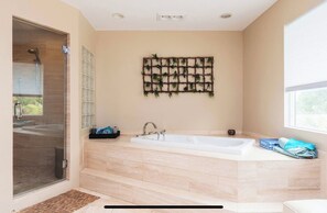 A modern bathroom with a large bathtub, a glass shower enclosure, and a wall-mounted plant shelf. - Rancho Santa Fe gated residence  (Encinitas)