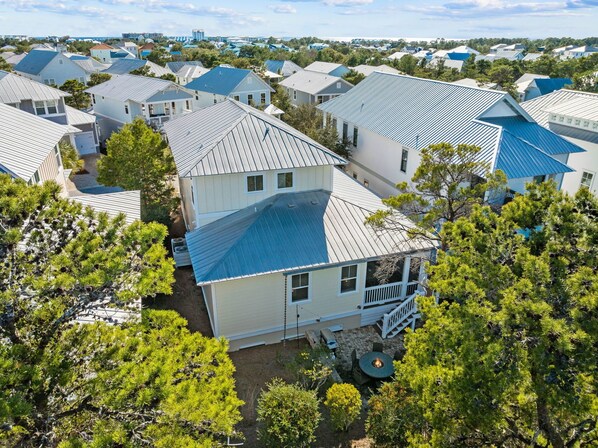 A residential area with multiple houses, each featuring a distinct architectural style and a variety of roof colors.