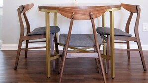 A dining area with a round table and four wooden chairs with cushioned seats. - Relaxing 2BR Getaway Near KU Med with Pool | 18 (Kansas City)