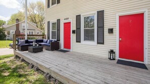 A two-story house with a covered porch, two red doors, and a number 4028 on the front. - Relaxing 2BR Getaway Near KU Med with Pool | 18 (Kansas City)