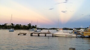 A marina with boats docked, a wooden pier, and a calm water body. - Beachfront Caribbean Paradise at Colony Cove (Christiansted)
