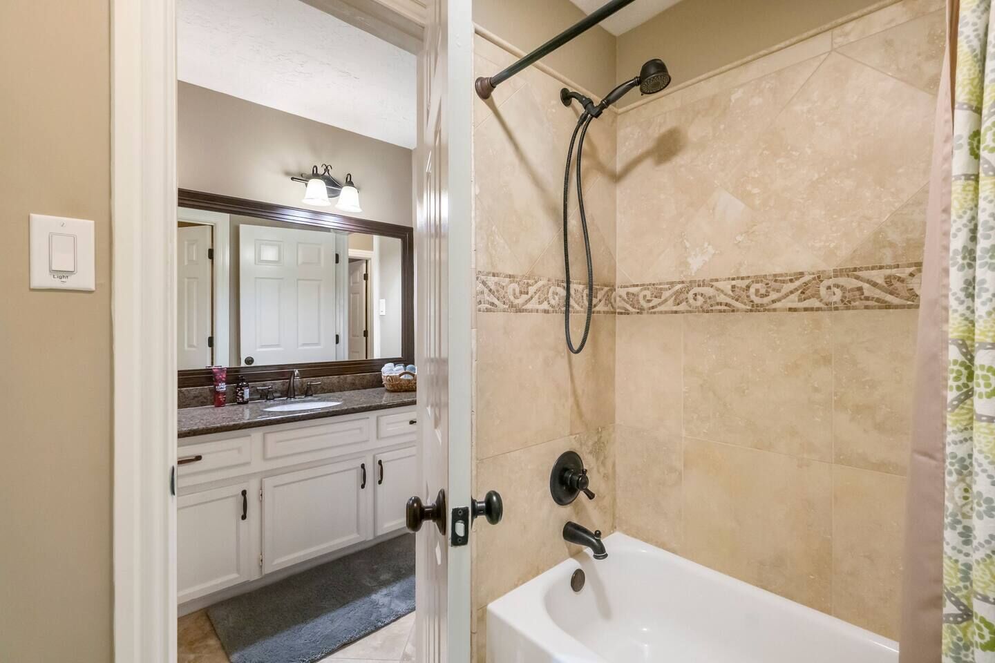 A bathroom with a shower, a sink, and a mirror.