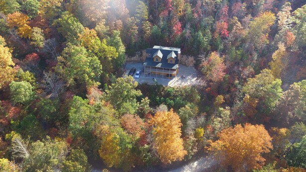 An aerial view of a house surrounded by autumn-colored trees. -  Secluded Mountainside Cabin, Close to Town, No 4 wheel drive needed!  Hot Tub! (Bryson City)