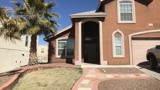 A two-story house with a garage, a palm tree, and a stone pathway leading to the entrance. - Westside El Paso Beautiful Big House lots of Perks contemporary nice Backyard (El Paso)