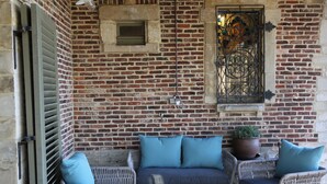 A brick wall with a window and a door.