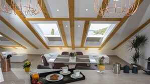 A dining area with a high ceiling, skylights, and a view of the outdoors. - Flowers Dubrovnik Luxury Apartments (Dubrovnik)