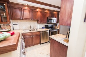 Enjoy cooking in this well-equipped kitchen with a sink, stove, and modern appliances.