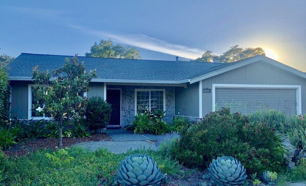A single-story house with a stone facade, a garage, and a well-maintained front yard with various plants. - Heated Swimming Pool Retreat Near Sonoma Square (Sonoma)