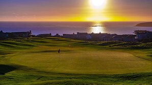A golf course with a sunset view of the ocean and houses in the background. - Luxury, Full Views, 6 Bedrooms/5 Full Baths, 3,800+ s.f., Pool Table, Hot Tub (Bodega Bay)
