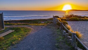 A paved pathway leading to a beach with a view of the ocean and a sunset. - Luxury, Full Views, 6 Bedrooms/5 Full Baths, 3,800+ s.f., Pool Table, Hot Tub (Bodega Bay)