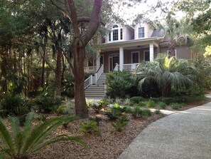 Beautiful palms and live oaks adorn the property