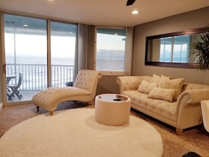 Relax in style with a plush sofa and ocean views.