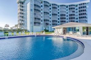 Enjoy a refreshing swim in the hotel's pool surrounded by lounge chairs and a covered seating area.