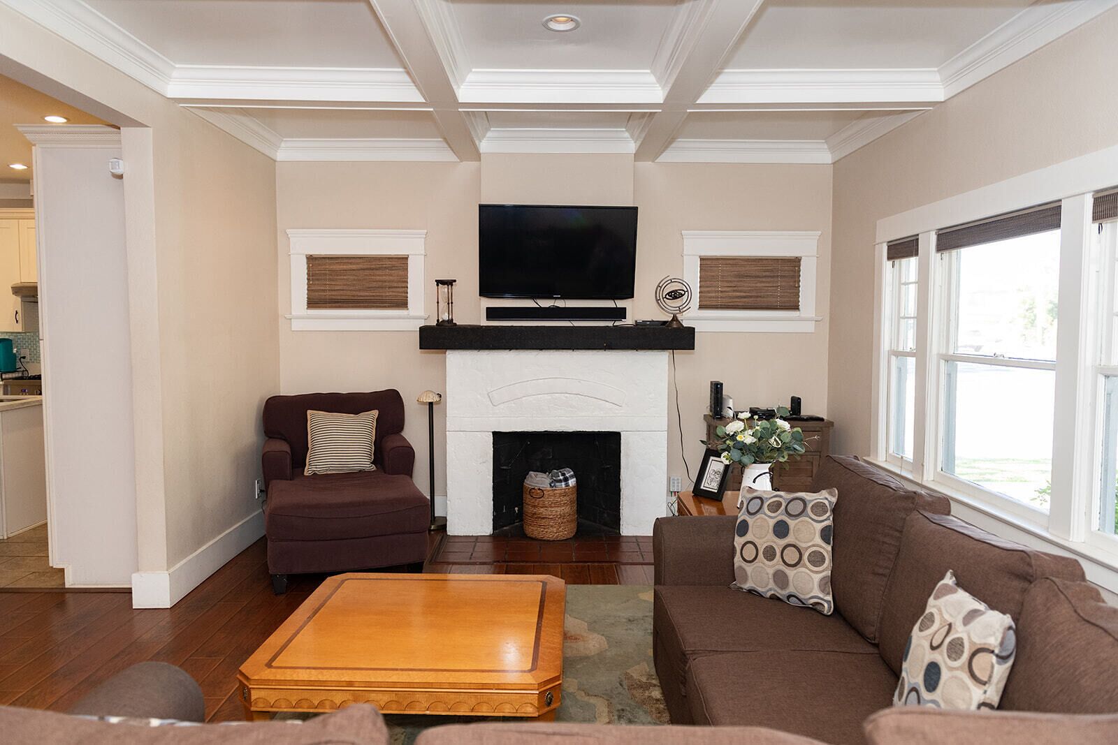 A living room with a fireplace, a television, and a sofa.