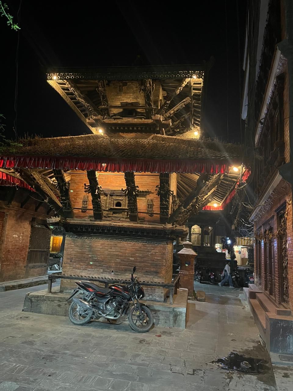 A traditional building with a tiled roof and a staircase leading to an upper level.