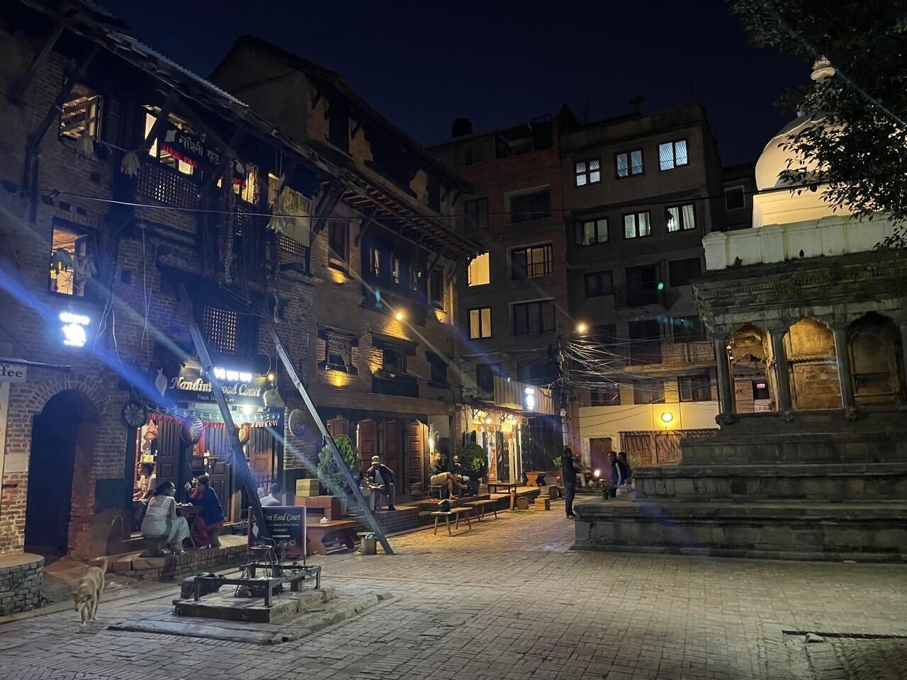 A historic building with multiple stories, a courtyard, and a dome structure.