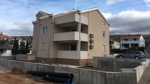 A multi-story building with a flat roof, likely a residential or mixed-use structure. - Apartment in Punat with Seaview, Terrace, Air condition, WIFI (4534-2) (Punat)