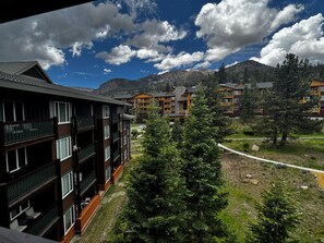 A multi-story hotel with balconies, surrounded by greenery and mountains. - Top-Floor Juniper Springs • Ski-In/Out • Views • Renovated • Sleeps 6 • A/C (Mammoth Lakes)