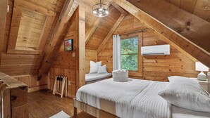 A wooden cabin bedroom with a loft bed, a window with curtains, and a ceiling light. - Falling Leaf Cabin Rustic Charm With Modern Decor! High Speed Internet!  (Rileyville)