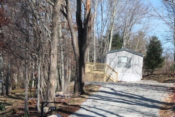 A small wooden cabin with a wooden deck and a staircase leading to a window. - QUIET & PEACEFUL IN THE HIGH COUNTRY MTNS TWEETSIE RR AND GRANDFATHER MT NEAR BY (Deep Gap)