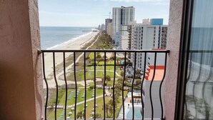 A balcony with a view of a beach and high-rise buildings. - +Serenity by the Sea+, Family Friendly, Best Views/ Location, Direct OF Corner! (Myrtle Beach)