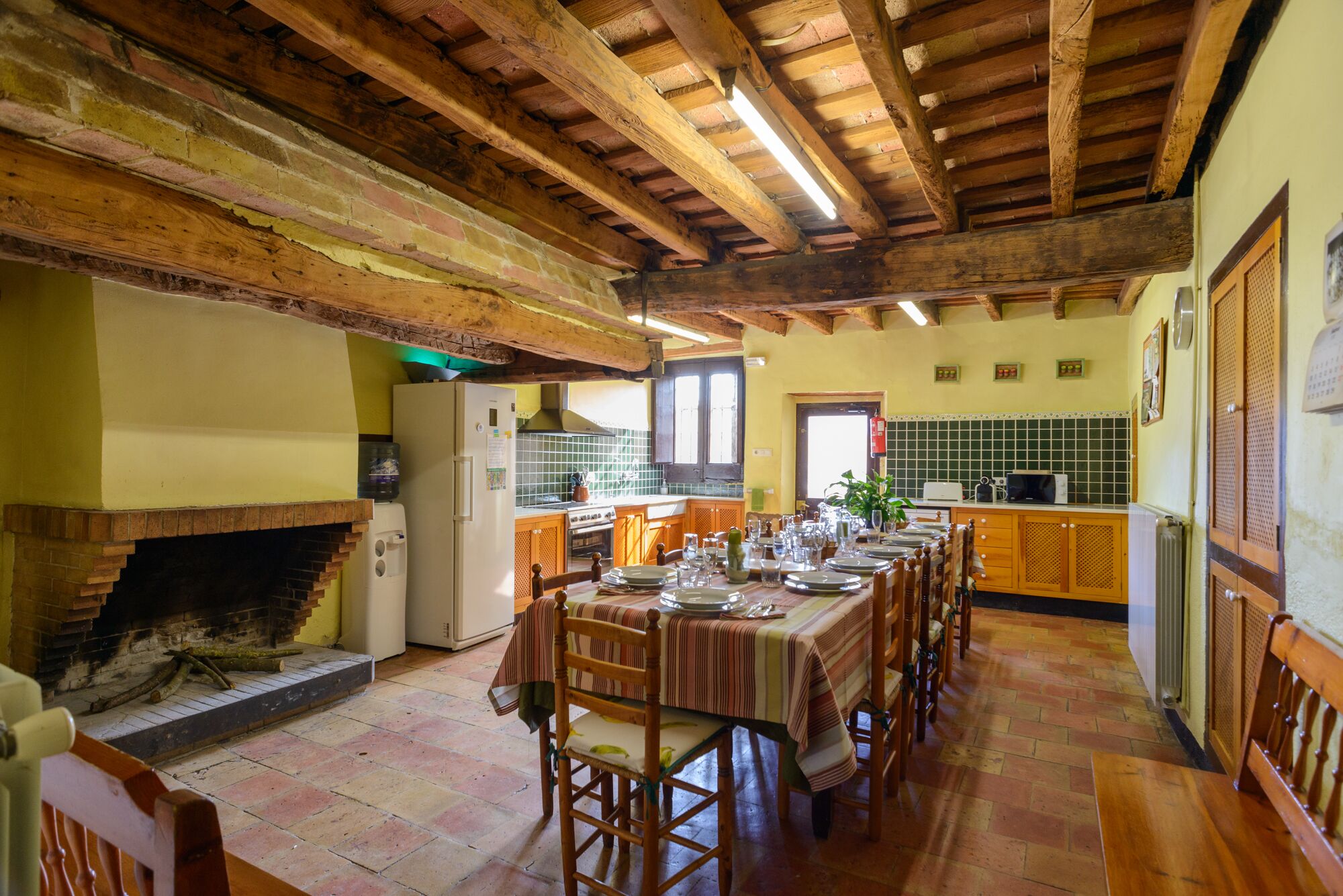 A rustic kitchen with a dining area set for a meal.