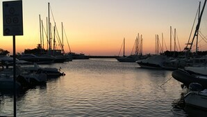 A marina with multiple boats docked at sunset. - "DESSANAI"
Villa with private garden, 5 minutes from the beach (Porto Ottiolu Budoni)