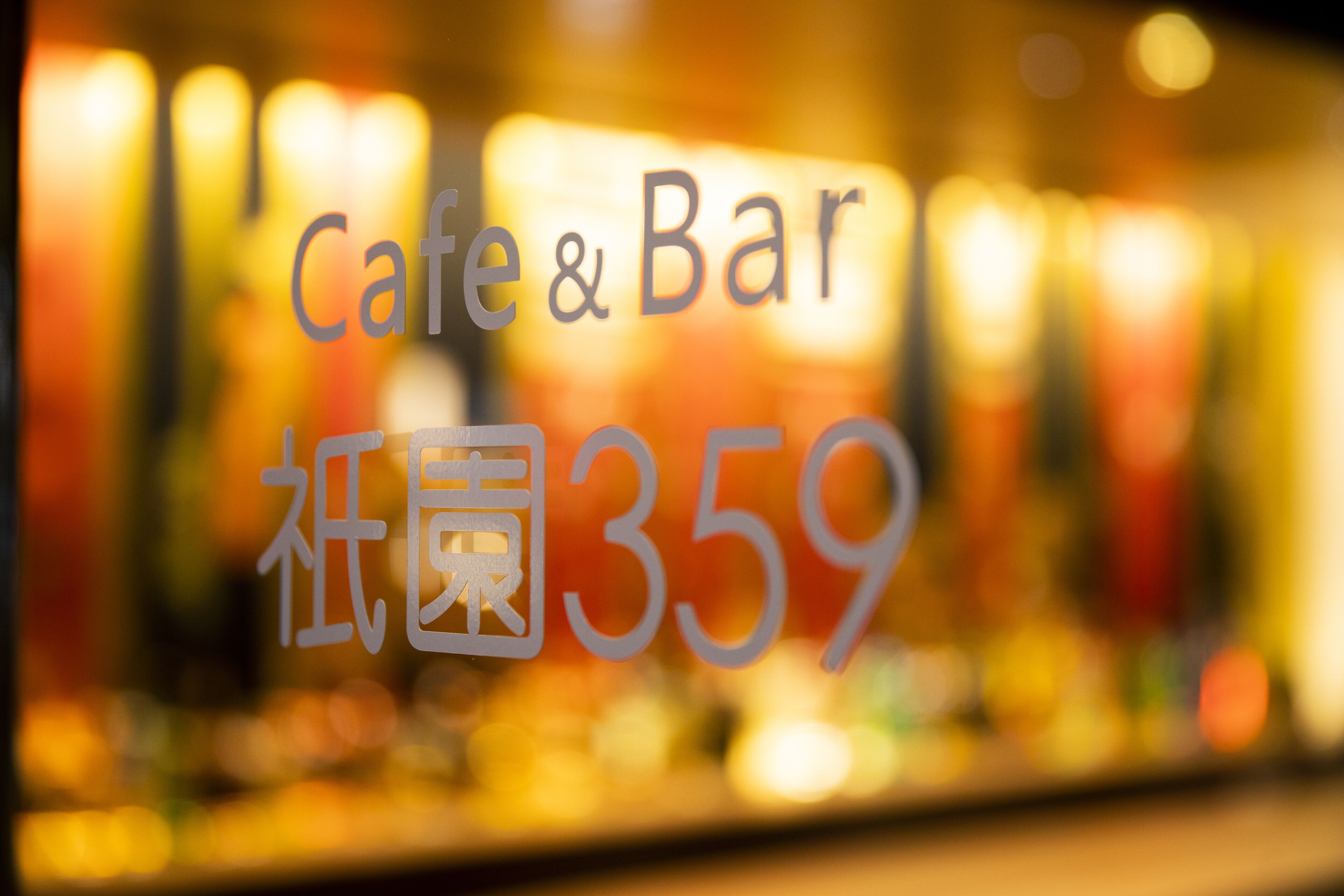 Interior borroso de un café y bar, con el nombre 'Cafe & Bar' y el número '359' a la vista.