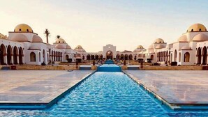 A swimming pool with a long, straight pathway leading to a building with multiple domed structures. - Luxury 4BD Villa with Pool in Hurghada (Hurghada)