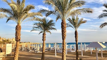 Private beach, white sand, beach shuttle, beach umbrellas