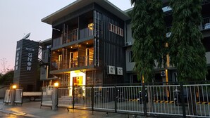A modern hotel with a two-story structure, balconies, and a visible entrance. - Hotel Snow Angeles (Angeles City)