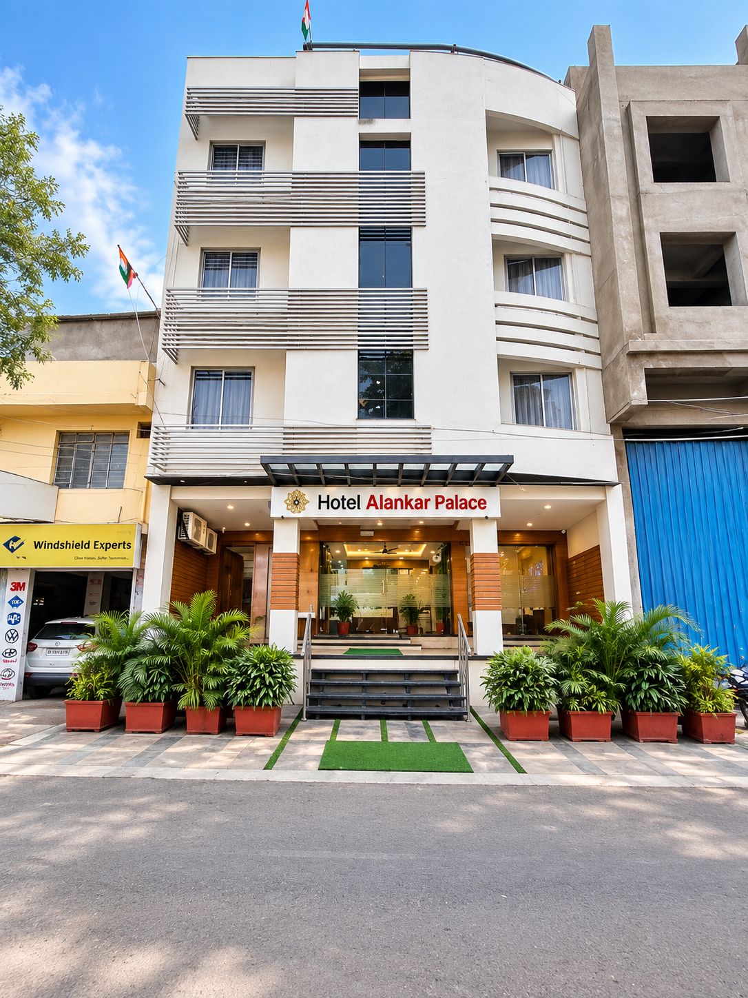 A multi-story hotel with a modern facade, a prominent entrance, and a flag.