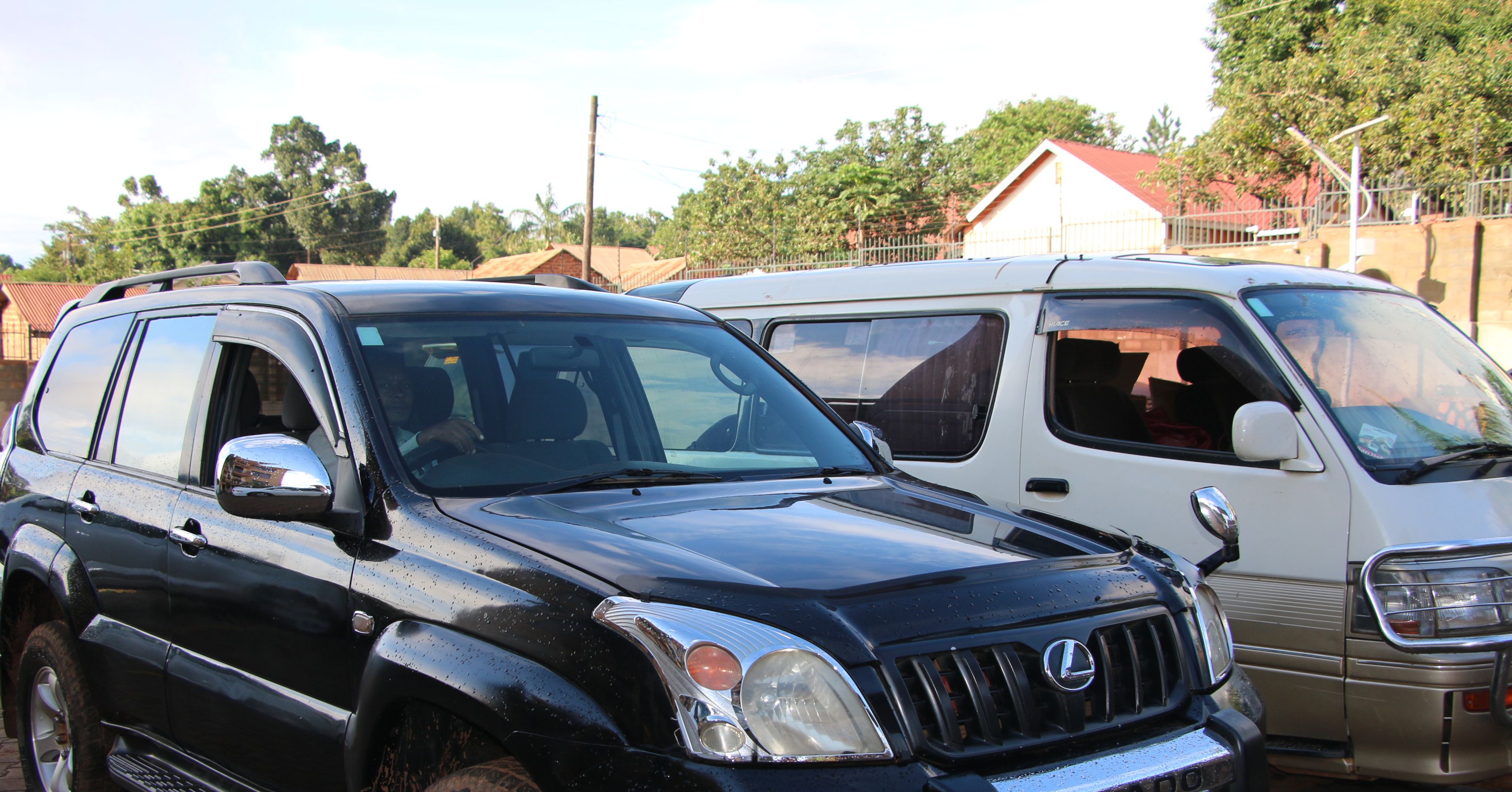 A black SUV and a white van parked side by side.