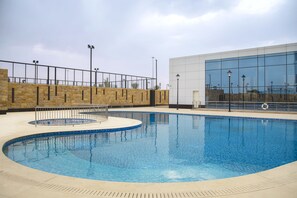 Alberca al aire libre y camastros 