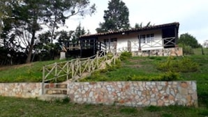 Une maison avec un mur en pierre et une clôture en bois.
