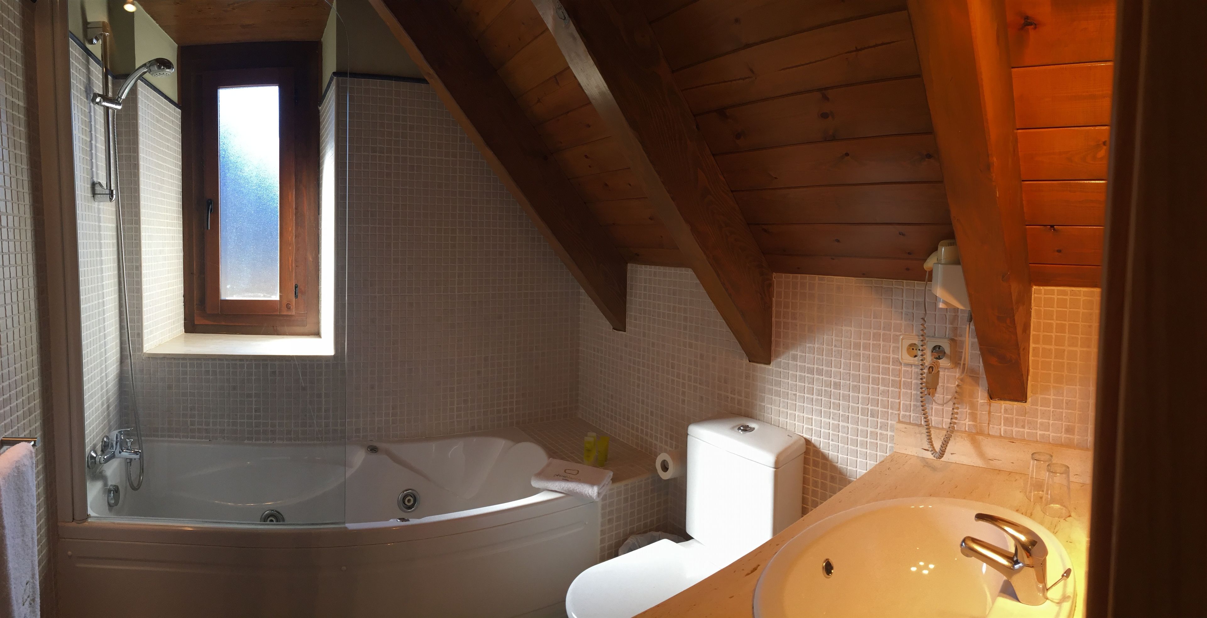 A bathroom with a bathtub, toilet, and sink.