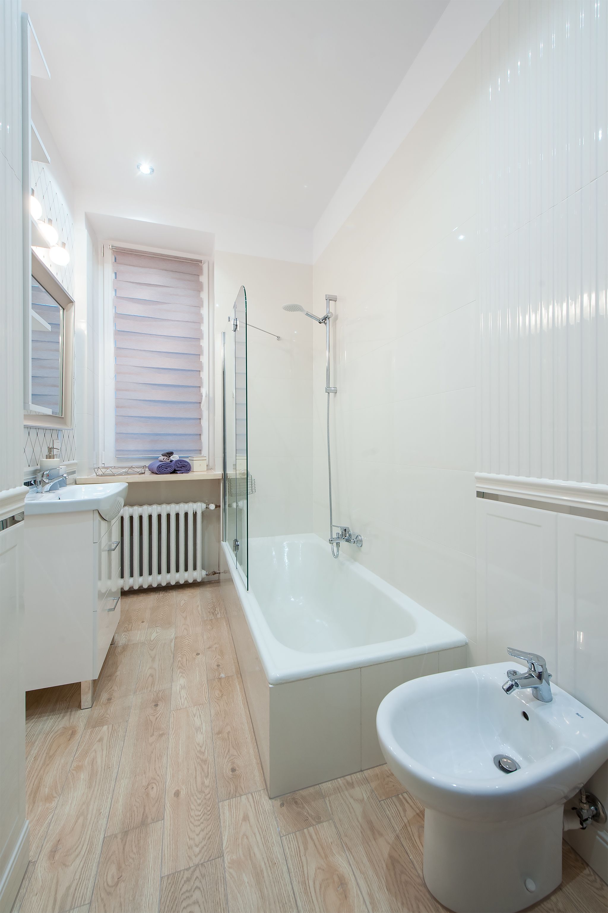 A modern bathroom with a bathtub, a sink, and a glass shower enclosure.