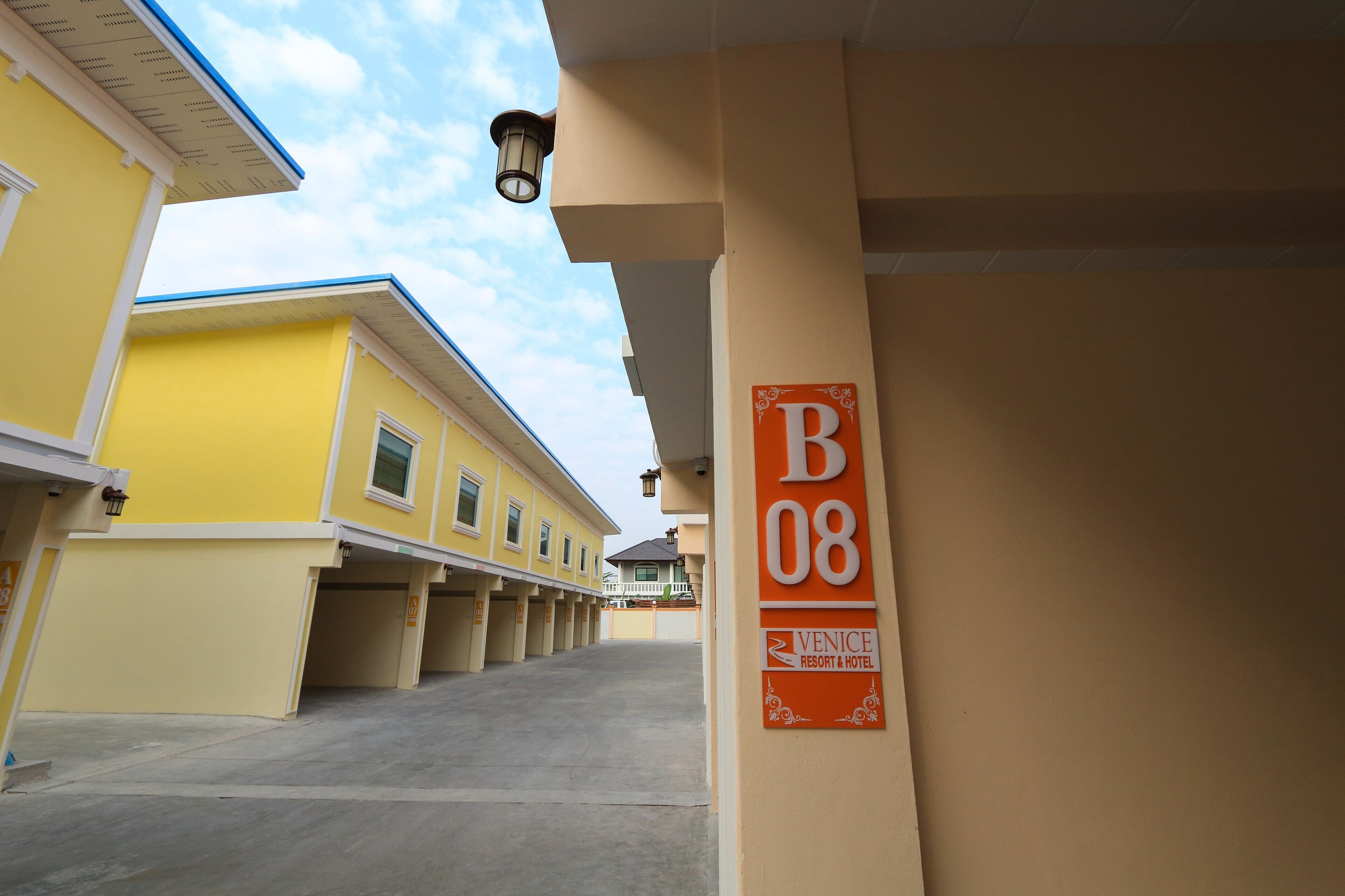 A parking area with a sign indicating 'B08' and 'Venice Resort & Hotel'.
