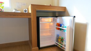 A compact refrigerator with a wooden frame, a built-in ice maker, and a freezer compartment. - Venice Resort (Lam Luk Ka)