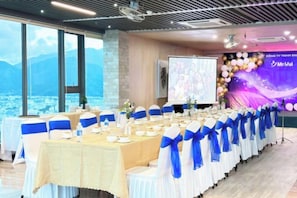 A conference room with a long table set for a meeting, large windows, and a presentation screen. - Emerald Bay Hotel & Spa Nha Trang (Nha Trang)