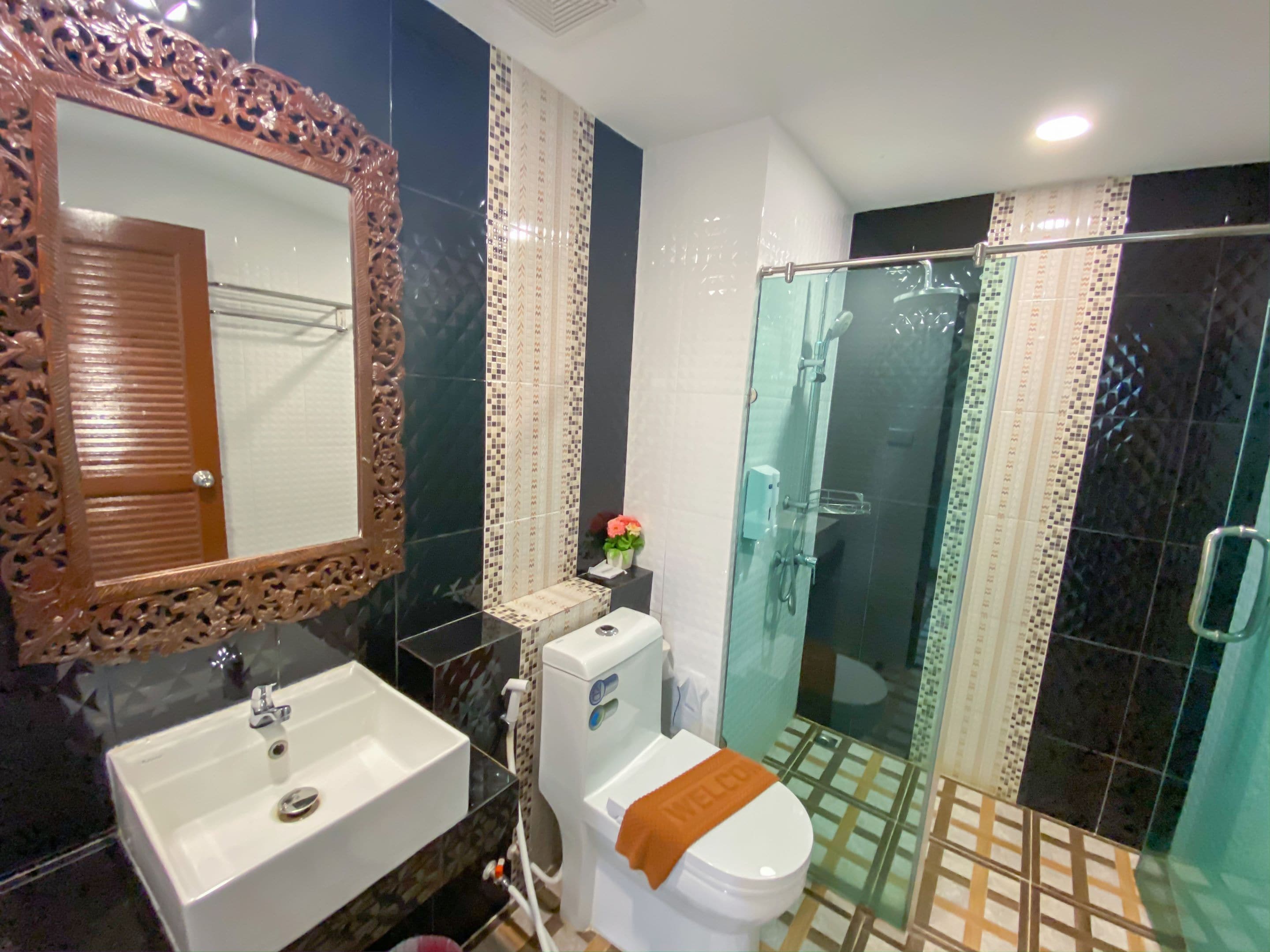 deluxe twin room | bathroom | shower, slippers, towels, soap