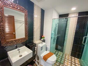 Deluxe Twin kamer | Badkamer | Een douche, pantoffels, handdoeken, zeep