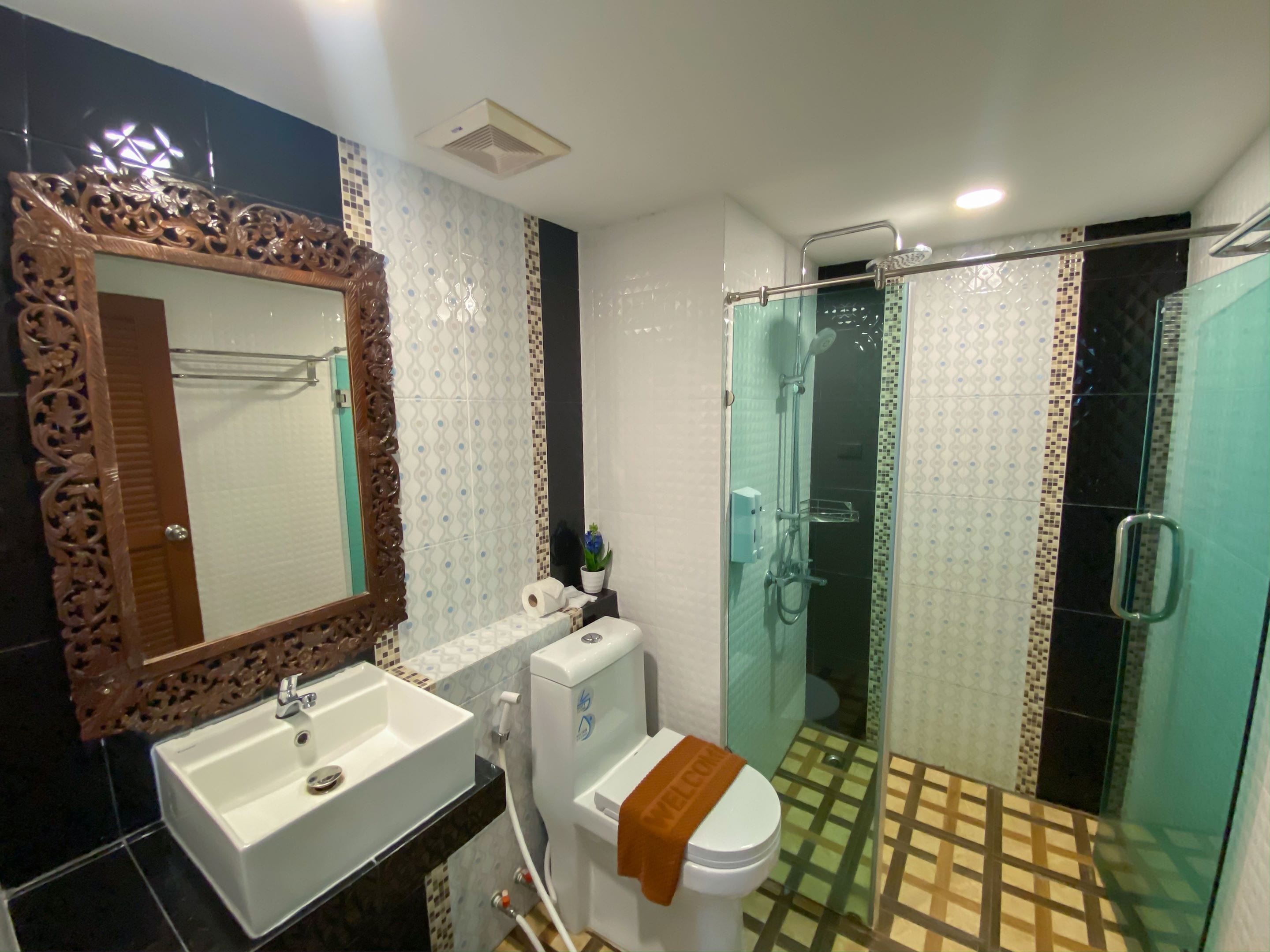 deluxe double room | bathroom | shower, slippers, towels, soap