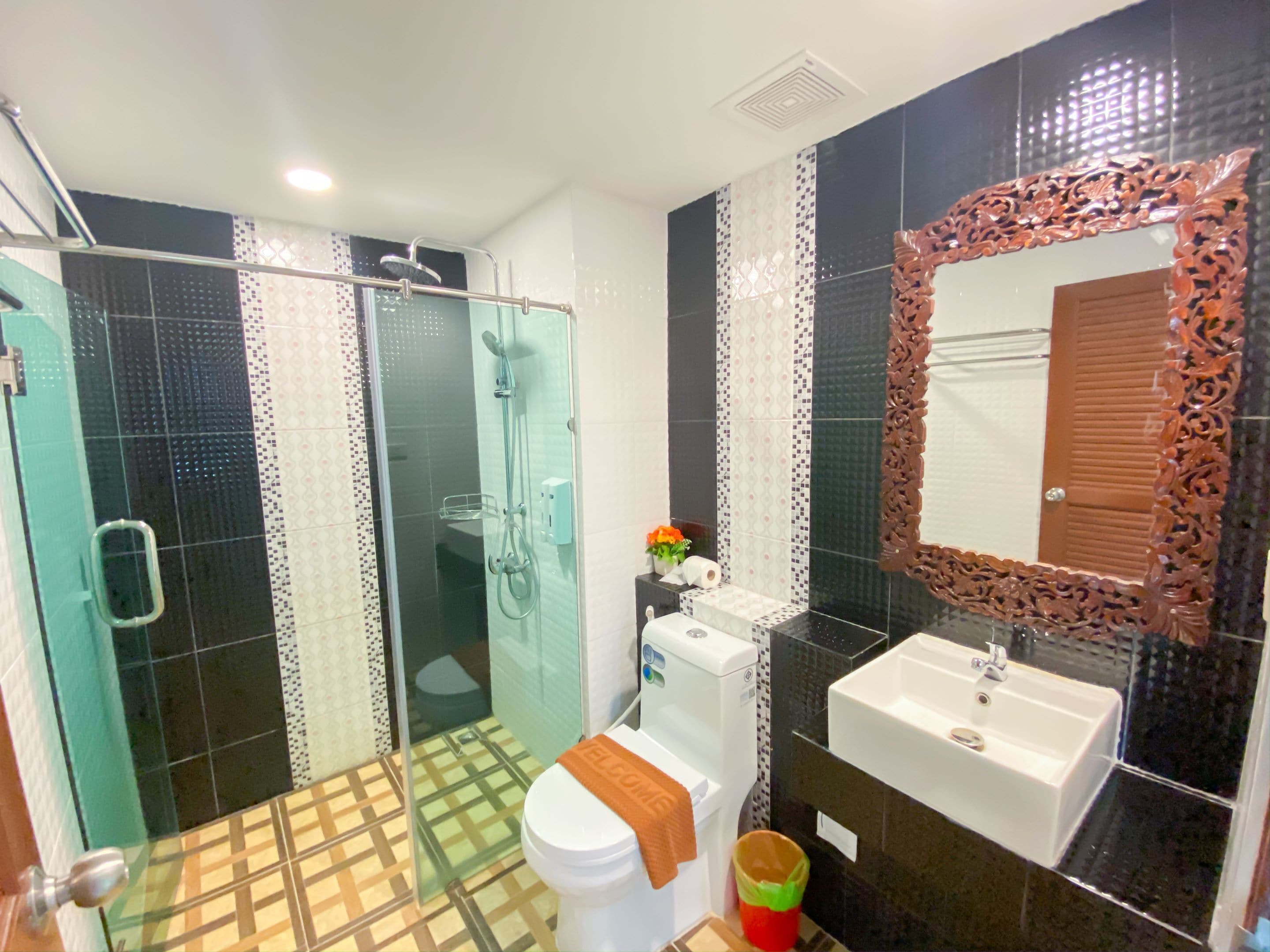 deluxe double room | bathroom | shower, slippers, towels, soap