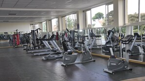 A gym with various cardio machines, large windows, and a clean, spacious layout. - Hotel Brovad Masaka (Masaka)