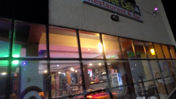 A coffee shop with large windows and a sign that reads "Coffee Cafe Restaurant & Bar". - Japs Motel Mbarara (Mbarara)