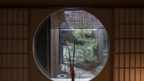 A traditional Japanese room with tatami flooring, a shoji screen, and a view of a garden. - Mimari (Kanazawa)