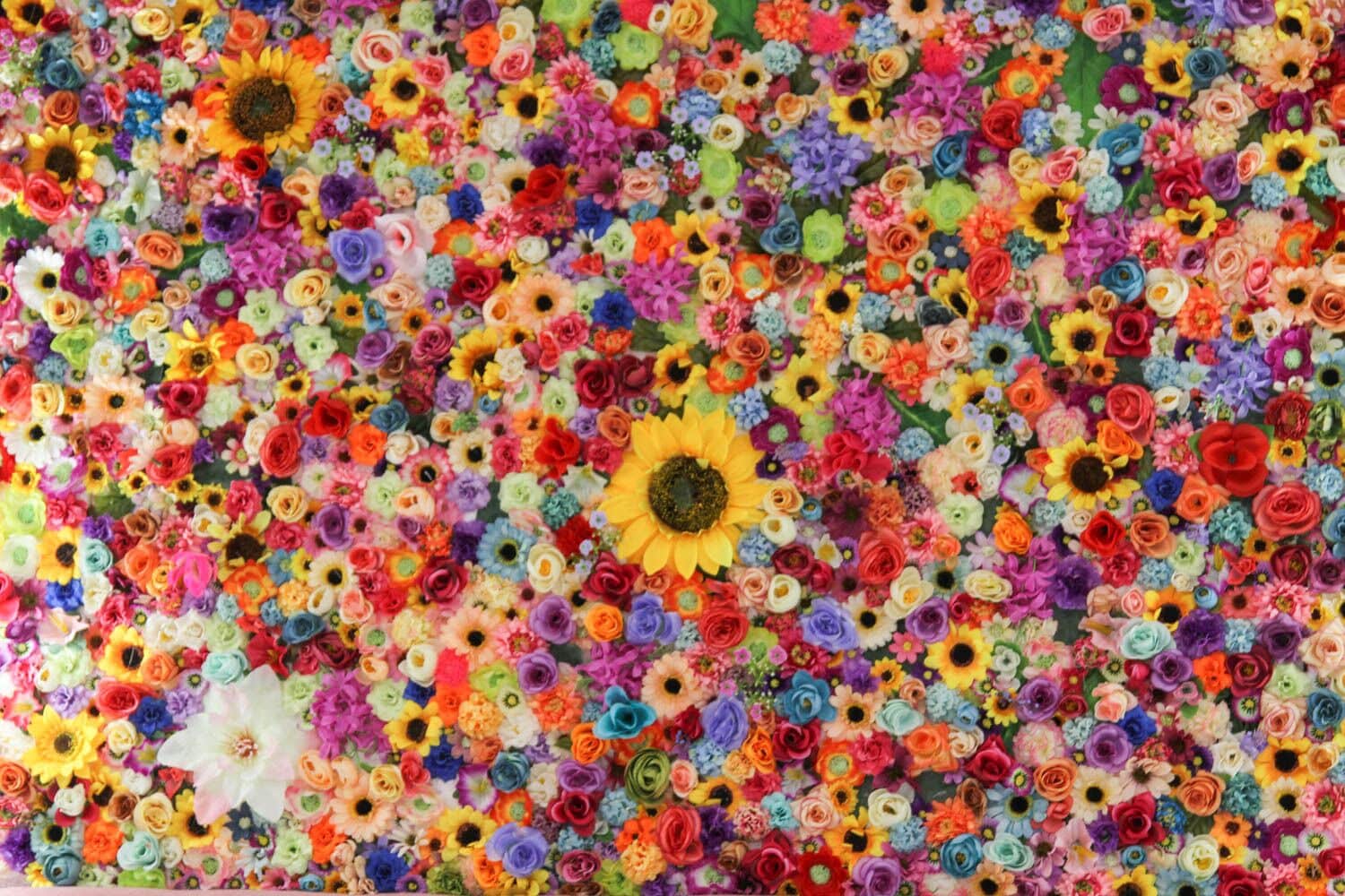 A large, colorful floral arrangement with various types of flowers and sunflowers.