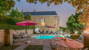A stone house with a swimming pool, outdoor seating, and a grill area. - Bettys Boutique Hotel (Mossel Bay)