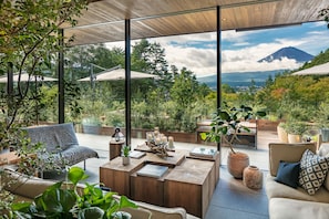 A modern outdoor seating area with a view of a mountain.